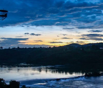 Sunset reflections over the Nile River and bungee jumping tower in Jinja, Uganda