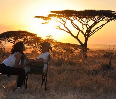 bridal couple sitting with sunset