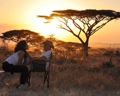 bridal couple sitting with sunset