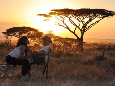 bridal couple sitting with sunset