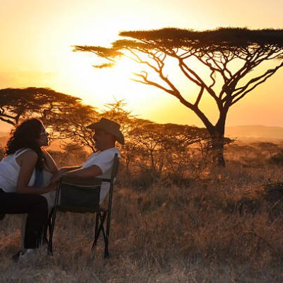 bridal couple sitting with sunset