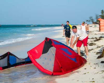 Zanzibar, Tanzania - Tourists enjoy in kiteboarding on the sandy beaches of Zanzibar.