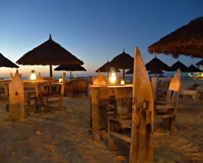zanzibar dinners Romantic night on Indian ocean shore. Beach cafe and lighting lanterns, Kendwa beach, Zanzibar, Tanzania, Africa. Selective focus on the lantern
